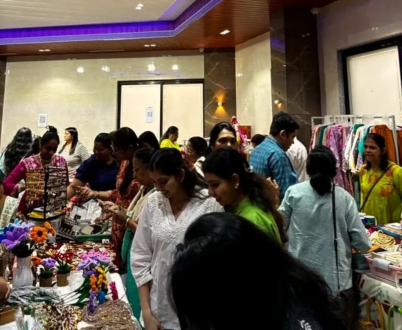 Shoppers browsing stalls of clothes and handmade goods at a festive exhibition organised by Mega Events